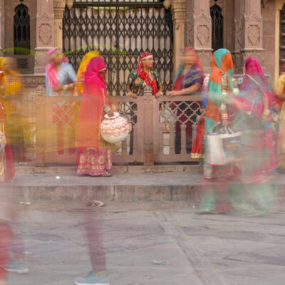 Women in saris carrying water containers in Jodhpur, India