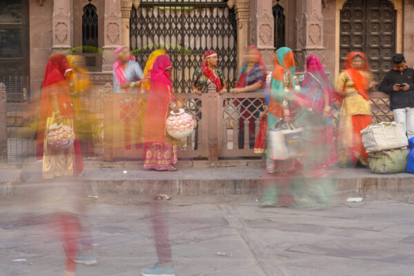 Women in saris carrying water containers in Jodhpur, India