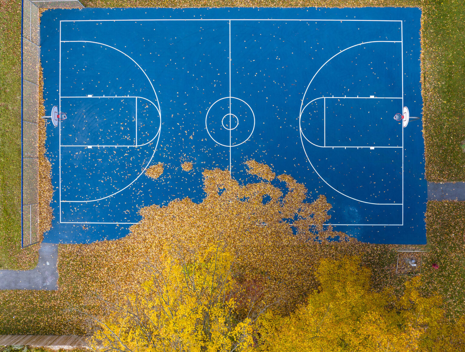Blue basketball court and yellow fall foliage, East Middlebury, Vermont